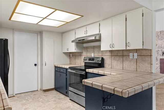 43 Zepher Way, Oroville, CA 95966 - kitchen with stainless steel electric range, under cabinet range hood, tasteful backsplash, and white cabinets