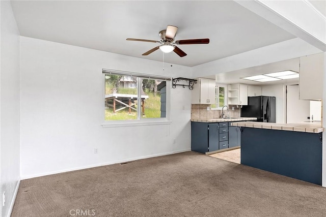 43 Zepher Way, Oroville, CA 95966 - kitchen with black fridge, a sink, tile counters, a ceiling fan, and light carpet