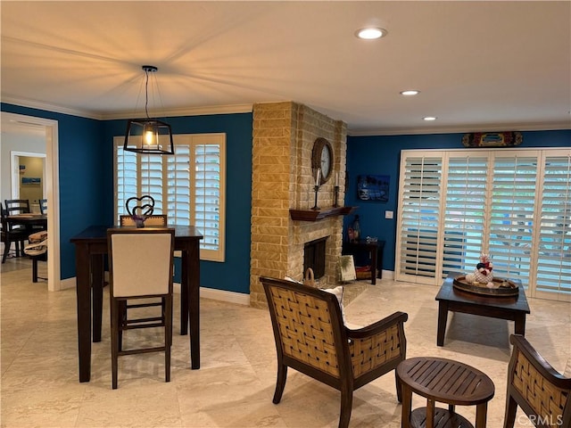 9033 Mandarin Ave, Rancho Cucamonga, CA 91701 - dining space featuring crown molding, healthy amount of natural light, a stone fireplace, baseboards, and recessed lighting