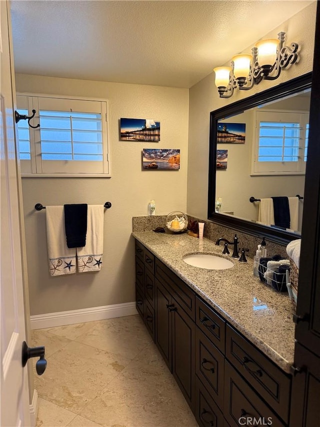 9033 Mandarin Ave, Rancho Cucamonga, CA 91701 - bathroom with vanity, baseboards, and a chandelier