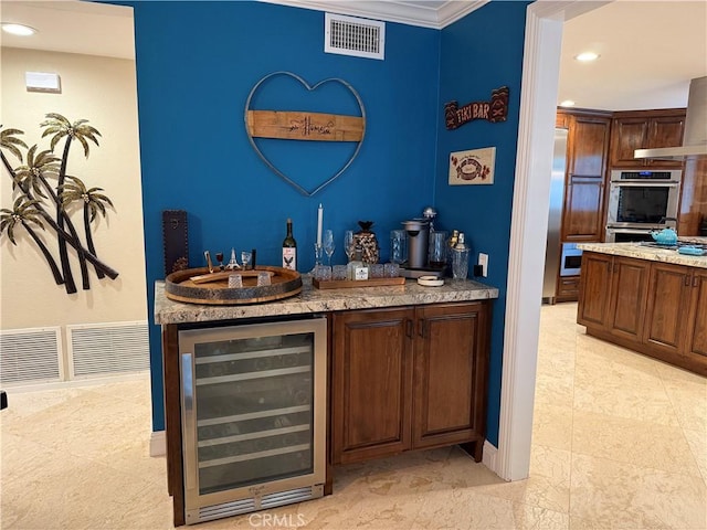 9033 Mandarin Ave, Rancho Cucamonga, CA 91701 - indoor wet bar featuring beverage cooler, recessed lighting, double oven, crown molding, and baseboards