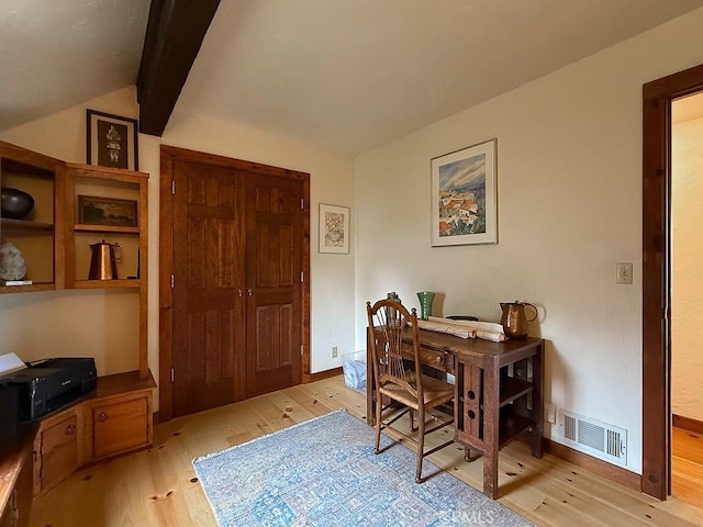 office area with light wood-style floors, visible vents, and vaulted ceiling with beams