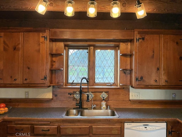 kitchen with a sink, dark countertops, white dishwasher, brown cabinets, and open shelves