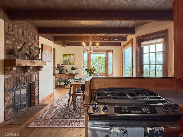 dining space featuring wood-type flooring, an inviting chandelier, and a healthy amount of sunlight