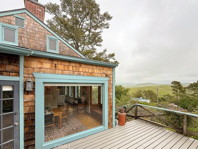 wooden deck with a mountain view