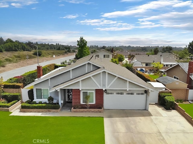 view of front of property featuring concrete driveway, an attached garage, a chimney, and a residential view
