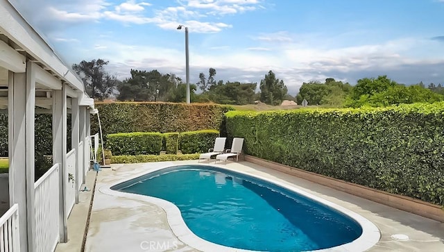view of swimming pool with a patio, a fenced in pool, and a fenced backyard
