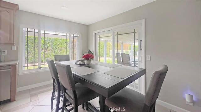 dining room with baseboards and light tile patterned floors