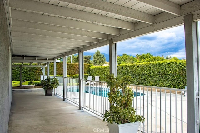 view of patio with fence and a fenced in pool