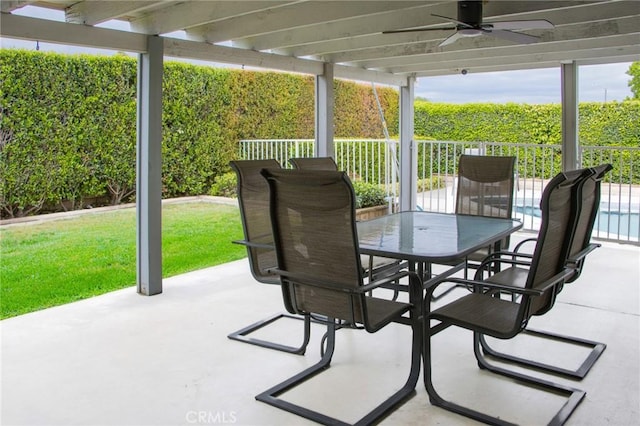 view of patio featuring outdoor dining area and a ceiling fan
