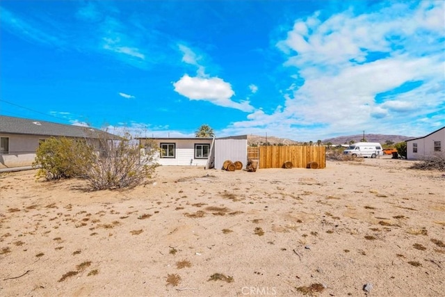 6558 Juniper Ave Unit 29, Palms, CA 92277 - rear view of property with fence and a mountain view