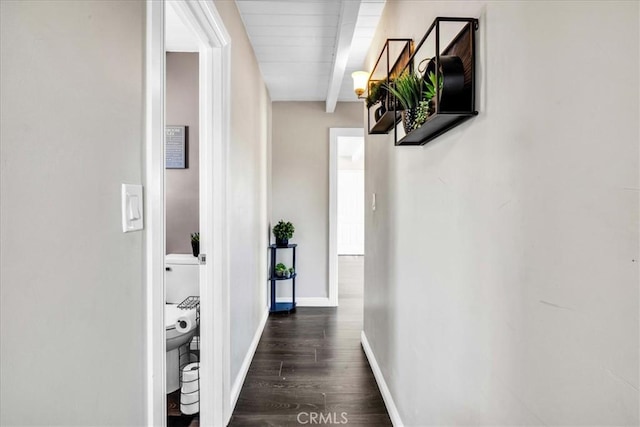 6558 Juniper Ave Unit 29, Palms, CA 92277 - hallway with beamed ceiling, baseboards, and dark wood-style flooring