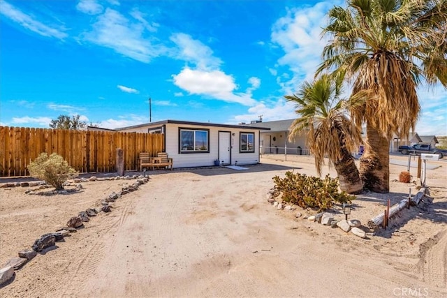 6558 Juniper Ave Unit 29, Palms, CA 92277 - view of front of property featuring dirt driveway and fence