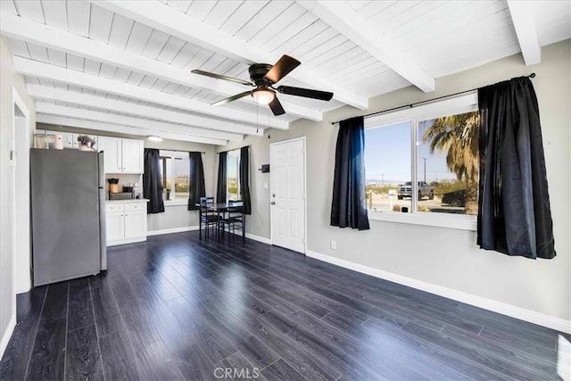 6558 Juniper Ave Unit 29, Palms, CA 92277 - unfurnished living room with beamed ceiling, baseboards, dark wood-type flooring, and ceiling fan