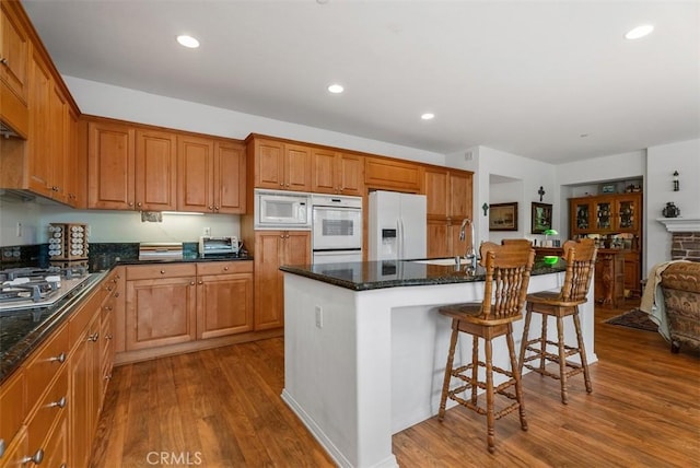 18 Corte Sevilla, San Clemente, CA 92673 - kitchen featuring white appliances, a sink, wood finished floors, a kitchen breakfast bar, and recessed lighting