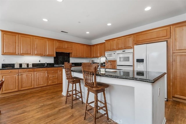 18 Corte Sevilla, San Clemente, CA 92673 - kitchen with white appliances, a sink, light wood-style floors, recessed lighting, and dark stone counters