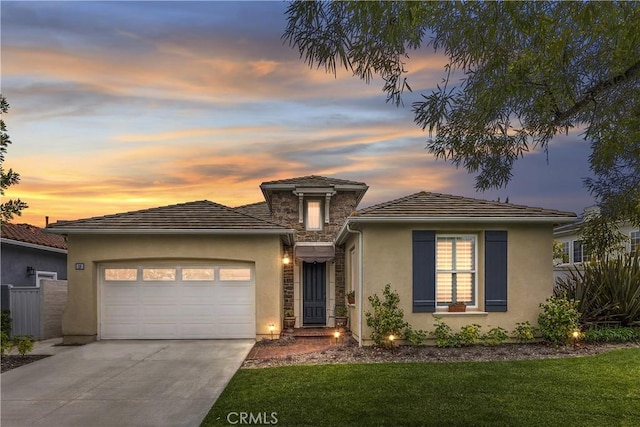 18 Corte Sevilla, San Clemente, CA 92673 - prairie-style house featuring an attached garage, driveway, stucco siding, and stone siding