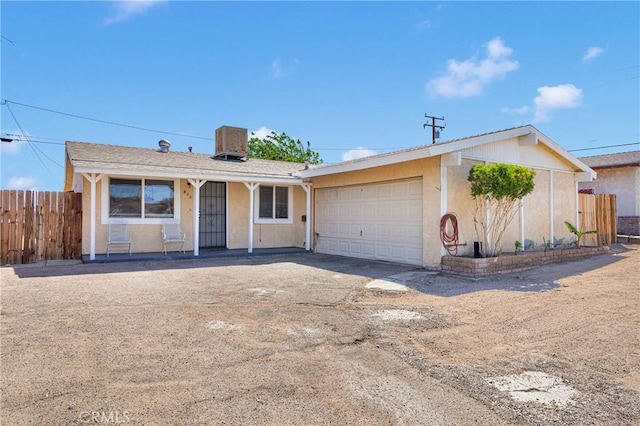 305 Beverly Ave, Barstow, CA 92311 - ranch-style house with an attached garage, stucco siding, and driveway
