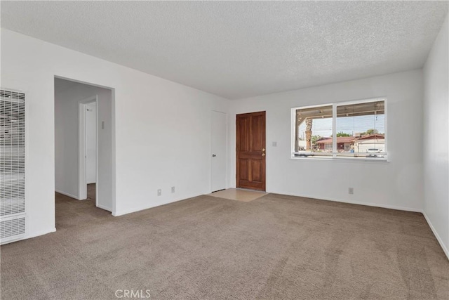 305 Beverly Ave, Barstow, CA 92311 - carpeted empty room featuring a heating unit and a textured ceiling