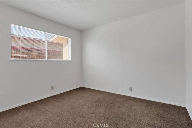 305 Beverly Ave, Barstow, CA 92311 - spare room featuring dark carpet and a textured ceiling