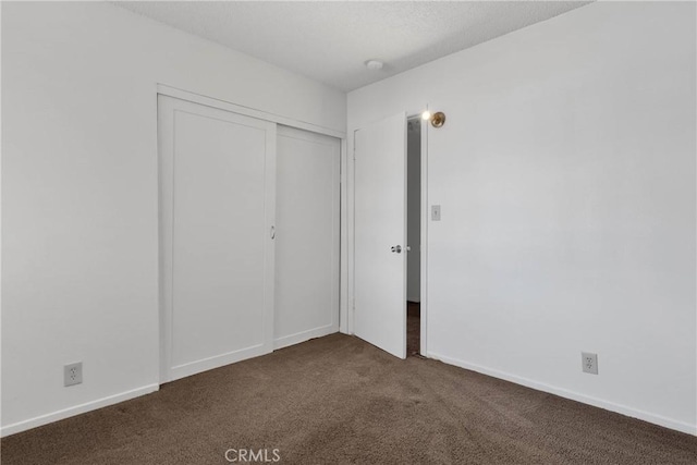 305 Beverly Ave, Barstow, CA 92311 - unfurnished bedroom featuring dark carpet and a closet