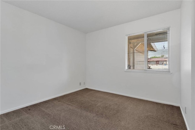 305 Beverly Ave, Barstow, CA 92311 - carpeted empty room featuring baseboards