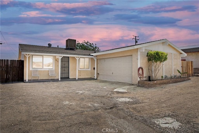 305 Beverly Ave, Barstow, CA 92311 - ranch-style house with an attached garage, stucco siding, and driveway