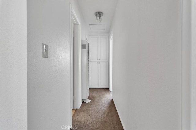 305 Beverly Ave, Barstow, CA 92311 - corridor with carpet flooring, a textured wall, attic access, and a heating unit