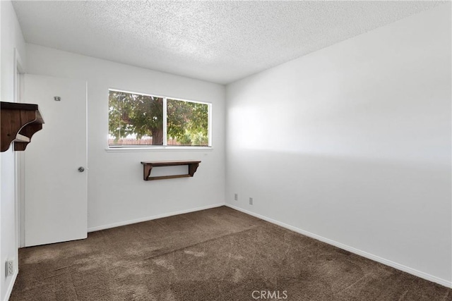 305 Beverly Ave, Barstow, CA 92311 - carpeted empty room with a textured ceiling and baseboards