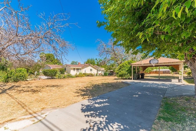 view of front of property with a detached carport and concrete driveway