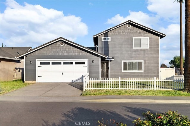 view of front facade with concrete driveway, fence private yard, and a garage