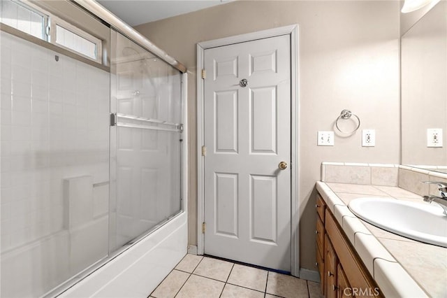 bathroom featuring vanity, tile patterned flooring, and bath / shower combo with glass door