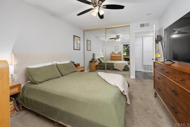 bedroom with a closet, visible vents, a ceiling fan, and carpet floors
