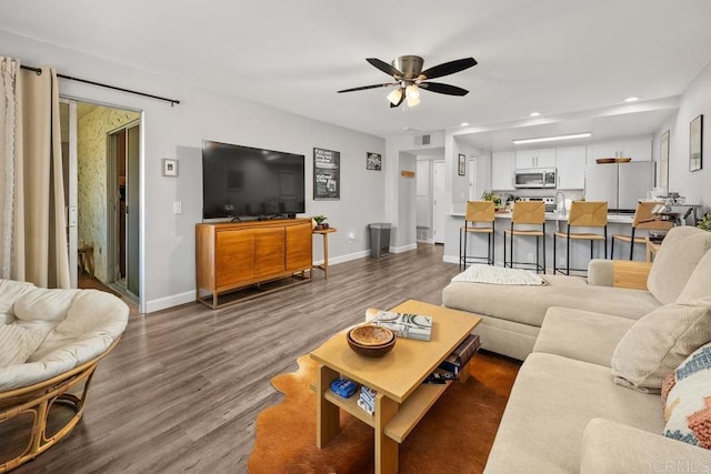 living area with wood finished floors, visible vents, recessed lighting, ceiling fan, and baseboards