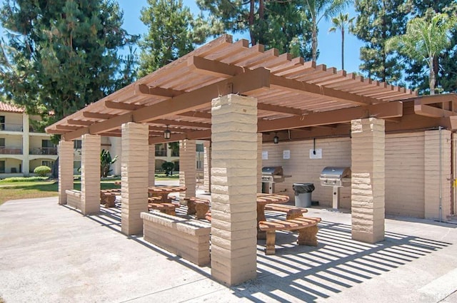view of patio with area for grilling, a pergola, and grilling area