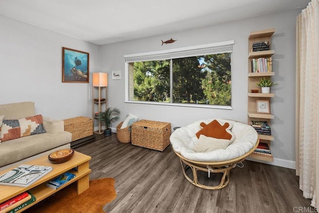 sitting room featuring baseboards and wood finished floors