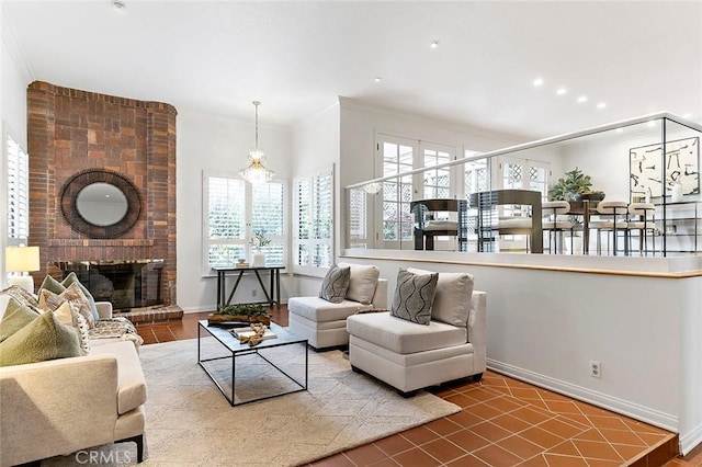living area with plenty of natural light, a brick fireplace, recessed lighting, and ornamental molding