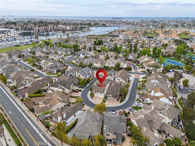 birds eye view of property with a water view and a residential view