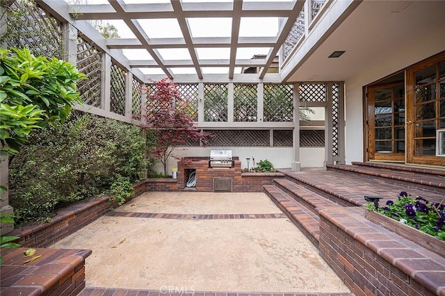 view of patio / terrace featuring exterior kitchen, a pergola, and a grill