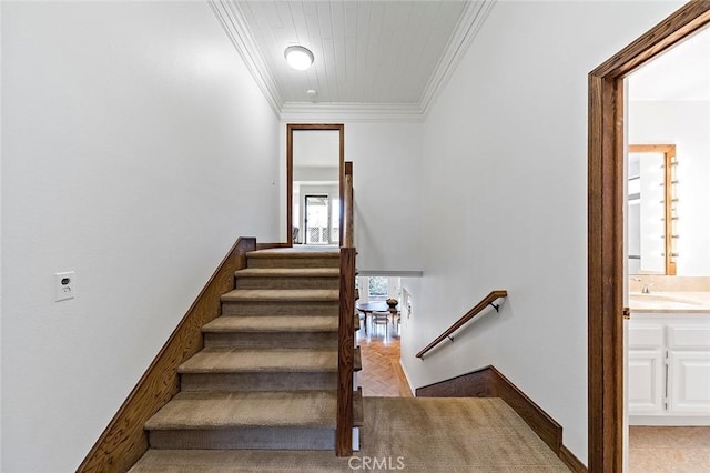 staircase with baseboards and crown molding