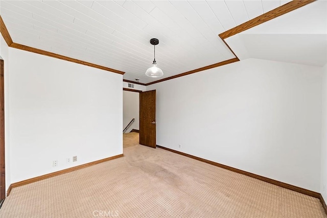 spare room featuring vaulted ceiling, baseboards, ornamental molding, carpet flooring, and visible vents