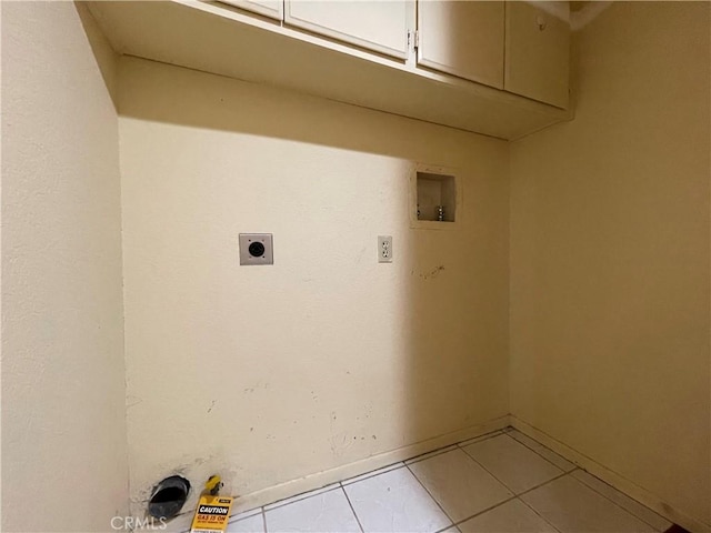 washroom with hookup for a washing machine, hookup for an electric dryer, light tile patterned flooring, cabinet space, and baseboards