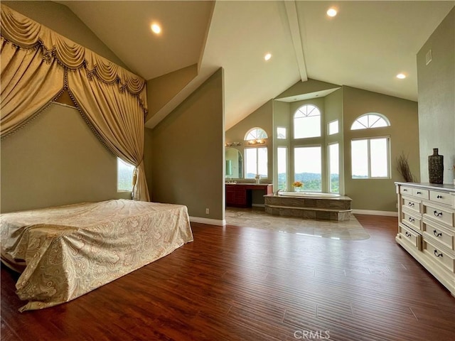 bedroom featuring baseboards, multiple windows, and vaulted ceiling with beams