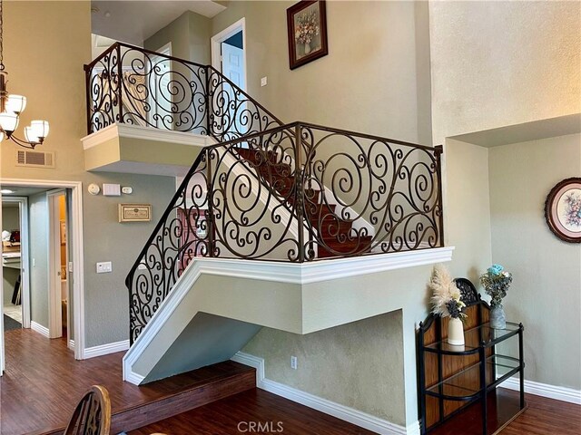 21062 Quail Run Dr, Diamond Bar, CA 91789 - stairs with a towering ceiling, wood finished floors, and a chandelier