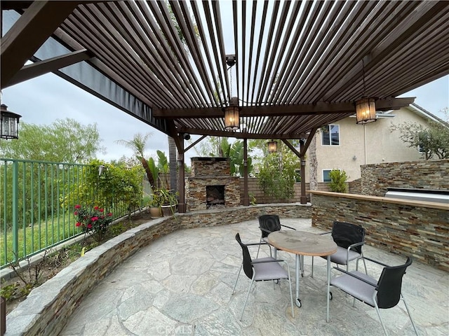 view of patio / terrace with a fenced backyard and an outdoor stone fireplace