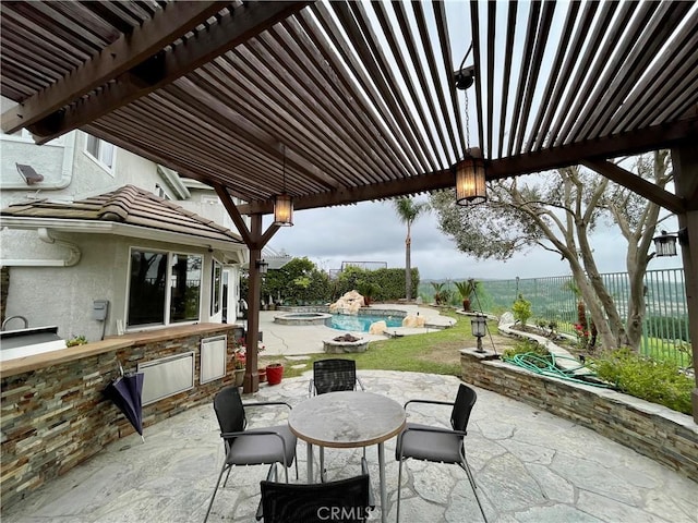 view of patio / terrace with an outdoor kitchen, a pergola, a fenced backyard, and outdoor dining area