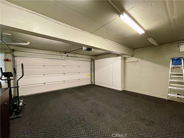 garage with baseboards and a garage door opener