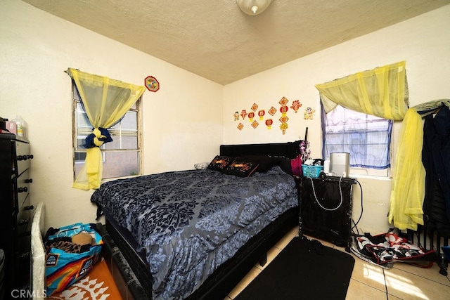 bedroom featuring tile patterned flooring and a textured ceiling