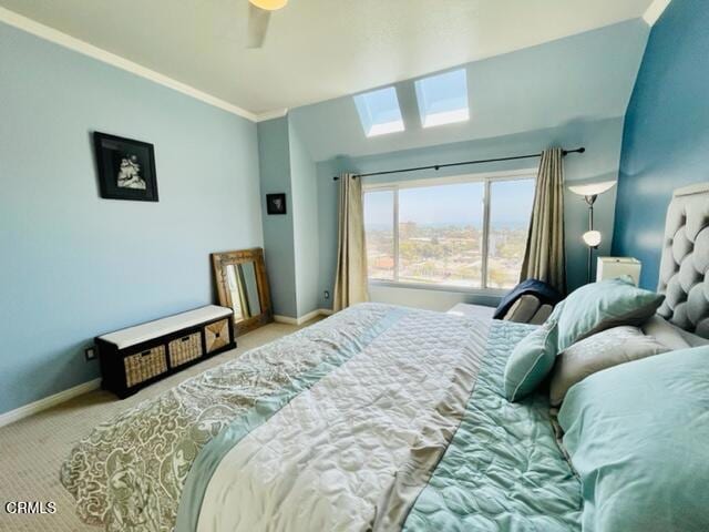 carpeted bedroom featuring a ceiling fan, baseboards, and crown molding
