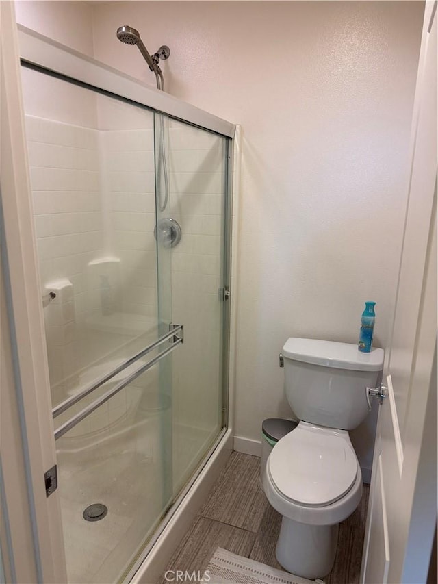 8823 Jacaranda Unit F, Montclair, CA 91763 - full bathroom with a stall shower, toilet, baseboards, and tile patterned floors